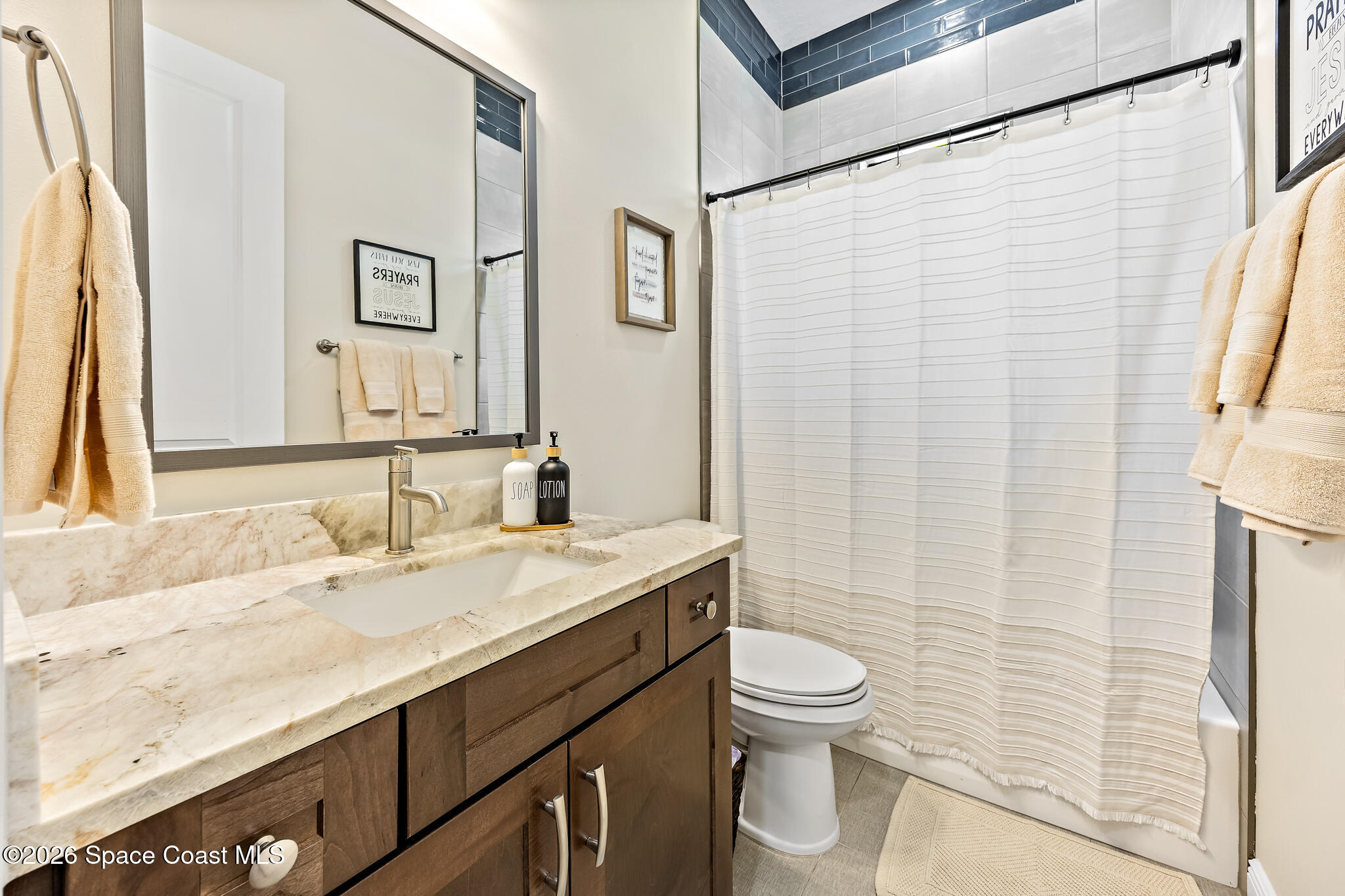 4055 Domain Court Melbourne, FL 32934 - Photo 31 of 49 a bathroom with a granite countertop sink toilet and shower