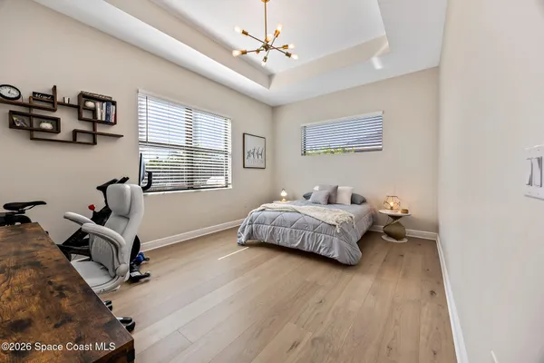 a bedroom with bed tv and window