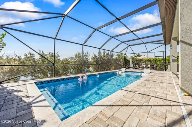 a view of a patio with swimming pool table and chairs