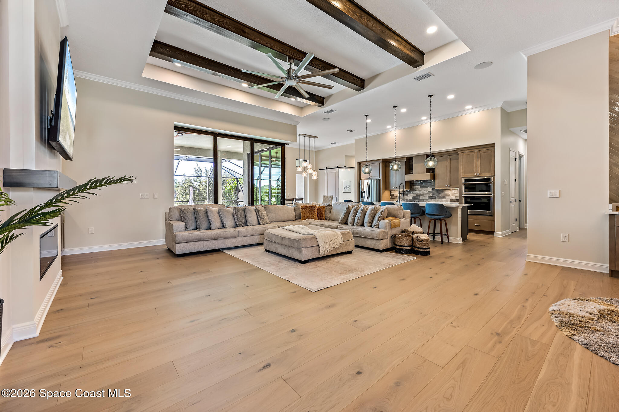 4055 Domain Court Melbourne, FL 32934 - Photo 3 of 49 a living room with furniture and a flat screen tv