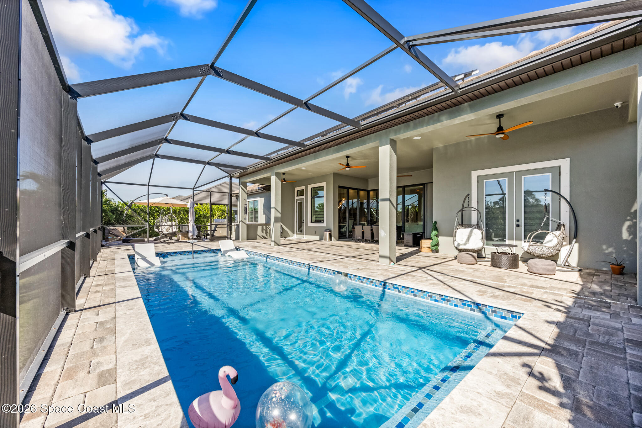 4055 Domain Court Melbourne, FL 32934 - Photo 40 of 49 a view of a patio with swimming pool table and chairs