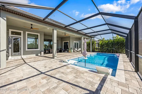 a view of a patio with a table and chairs under an umbrella