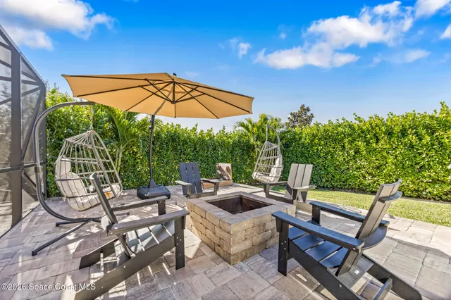 an aerial view of a house with a garden and outdoor seating