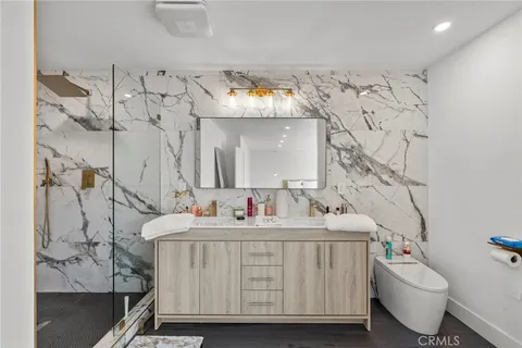 a bathroom with a sink toilet mirror and vanity