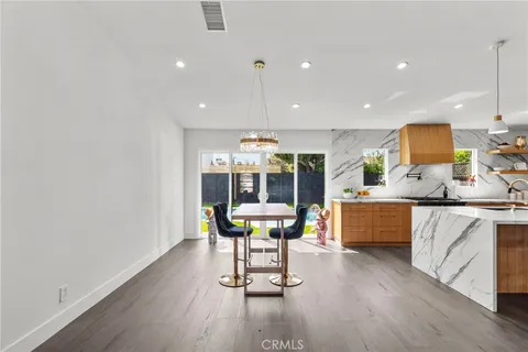 a kitchen with a sink cabinets and wooden floor