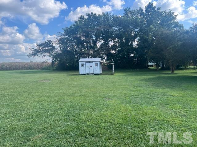 100 Lilly Street Dunn, NC 28334 - Photo 16 of 19 a view of a field of grass and trees