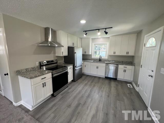 100 Lilly Street Dunn, NC 28334 - Photo 2 of 19 a kitchen with a white cabinets and white appliances
