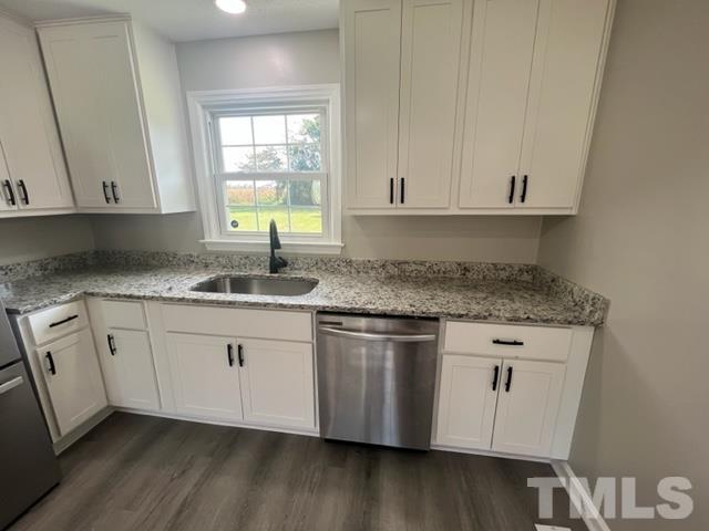 100 Lilly Street Dunn, NC 28334 - Photo 4 of 19 a kitchen with granite countertop cabinets stainless steel appliances a sink and a window
