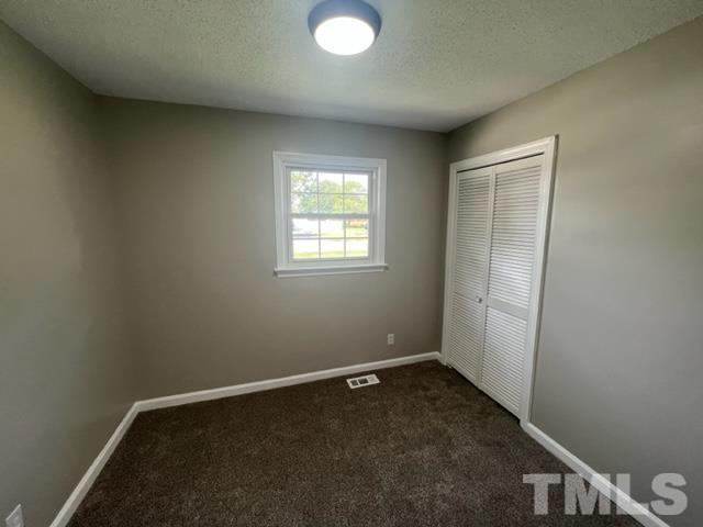 100 Lilly Street Dunn, NC 28334 - Photo 7 of 19 an empty room with windows