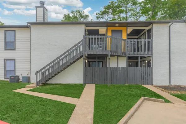 a view of house with backyard and deck