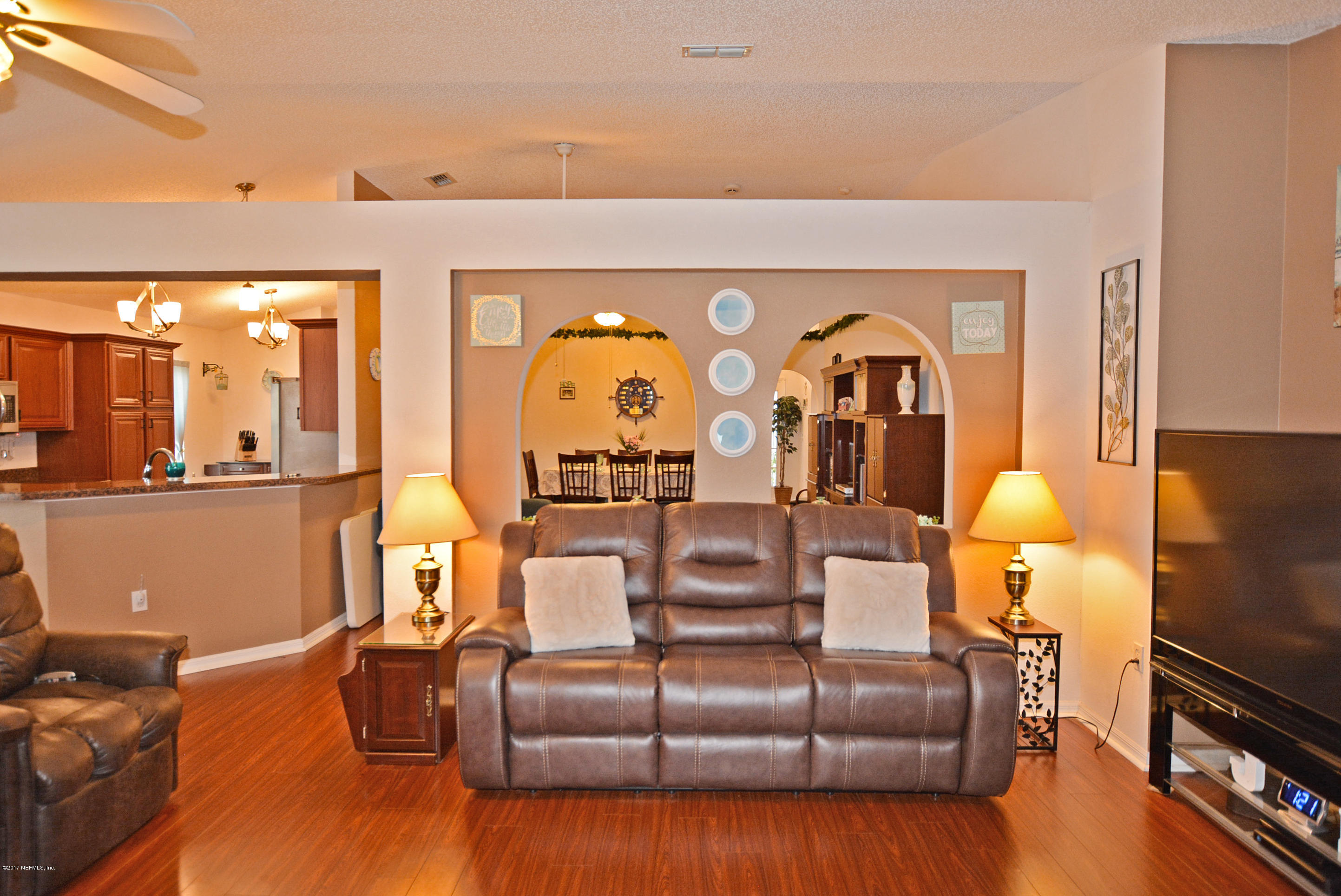 7319 Gum Tree Road Jacksonville, FL 32244 - Photo 15 of 41 a living room with furniture fireplace and a flat screen tv