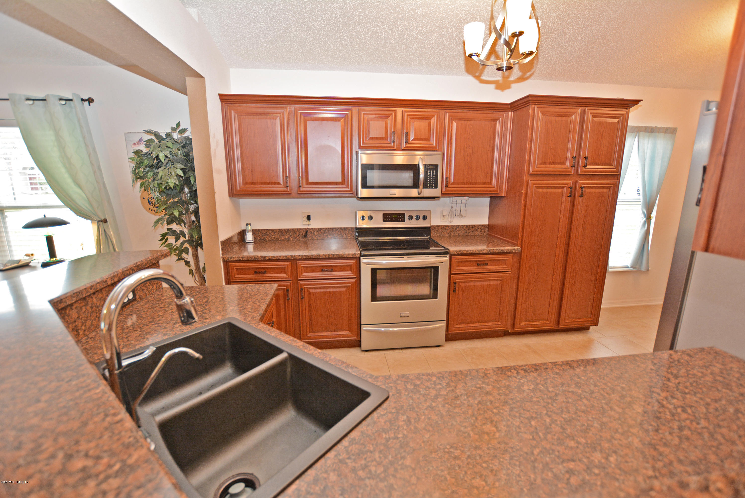 7319 Gum Tree Road Jacksonville, FL 32244 - Photo 25 of 41 a kitchen with stainless steel appliances a stove a sink and a refrigerator