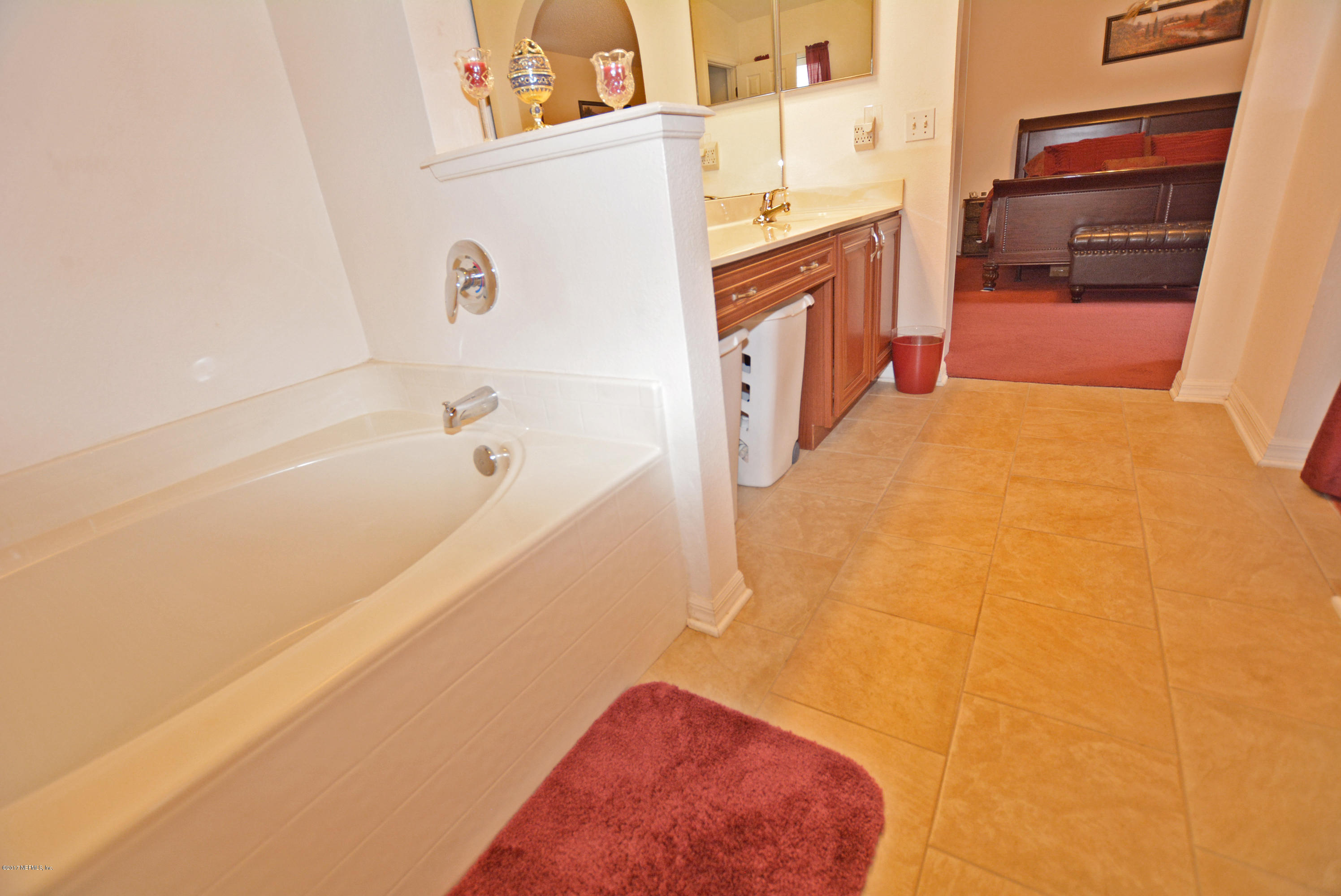 7319 Gum Tree Road Jacksonville, FL 32244 - Photo 28 of 41 a bathroom with a tub sink and a vanity