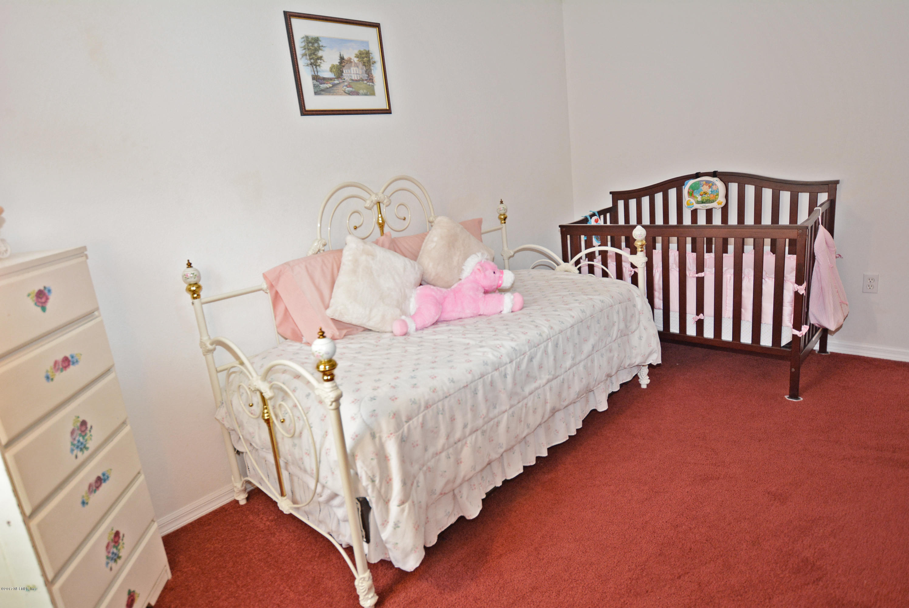 7319 Gum Tree Road Jacksonville, FL 32244 - Photo 30 of 41 a bedroom with bed and a window