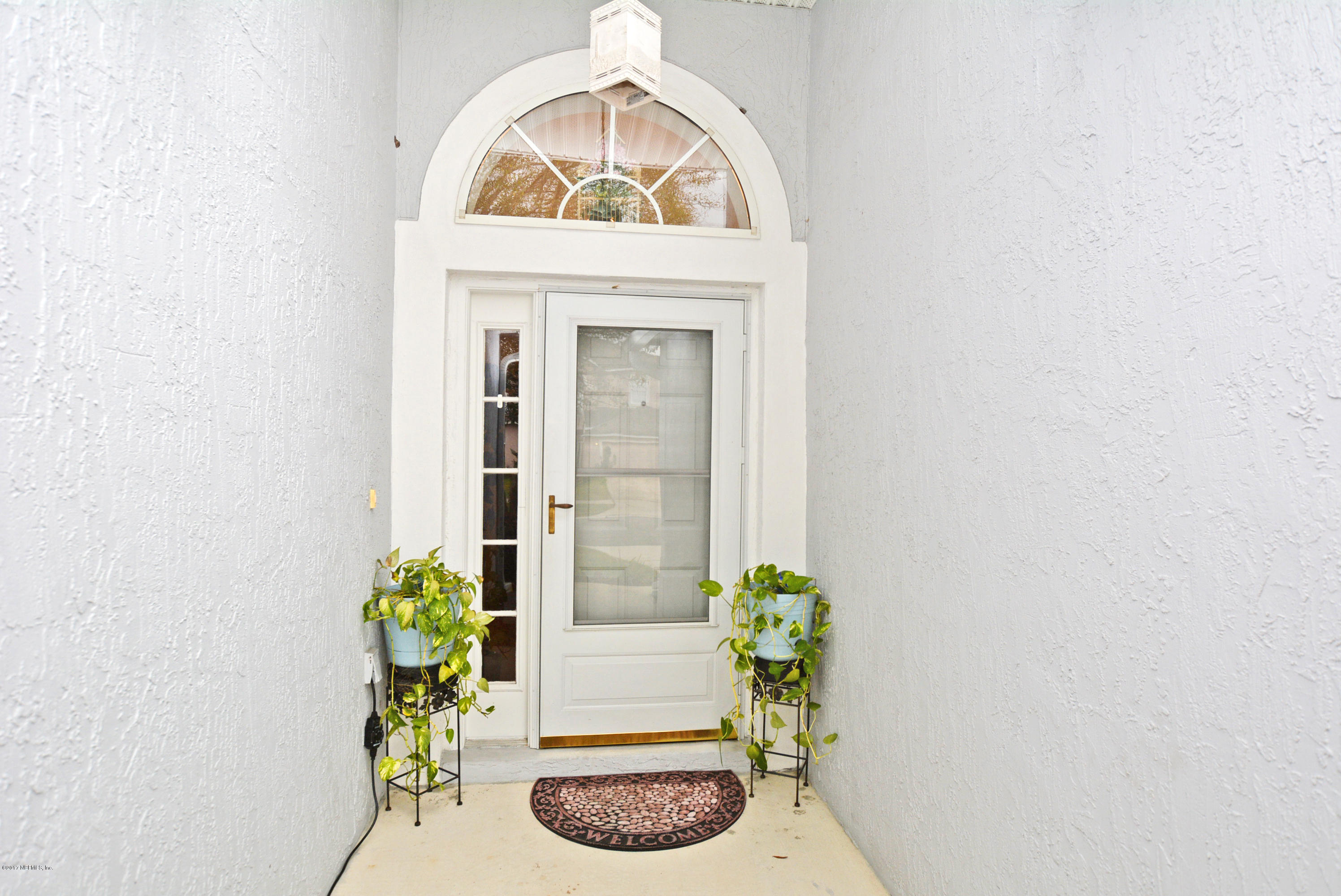 7319 Gum Tree Road Jacksonville, FL 32244 - Photo 3 of 41 a view of a dining room with a table and a potted plants