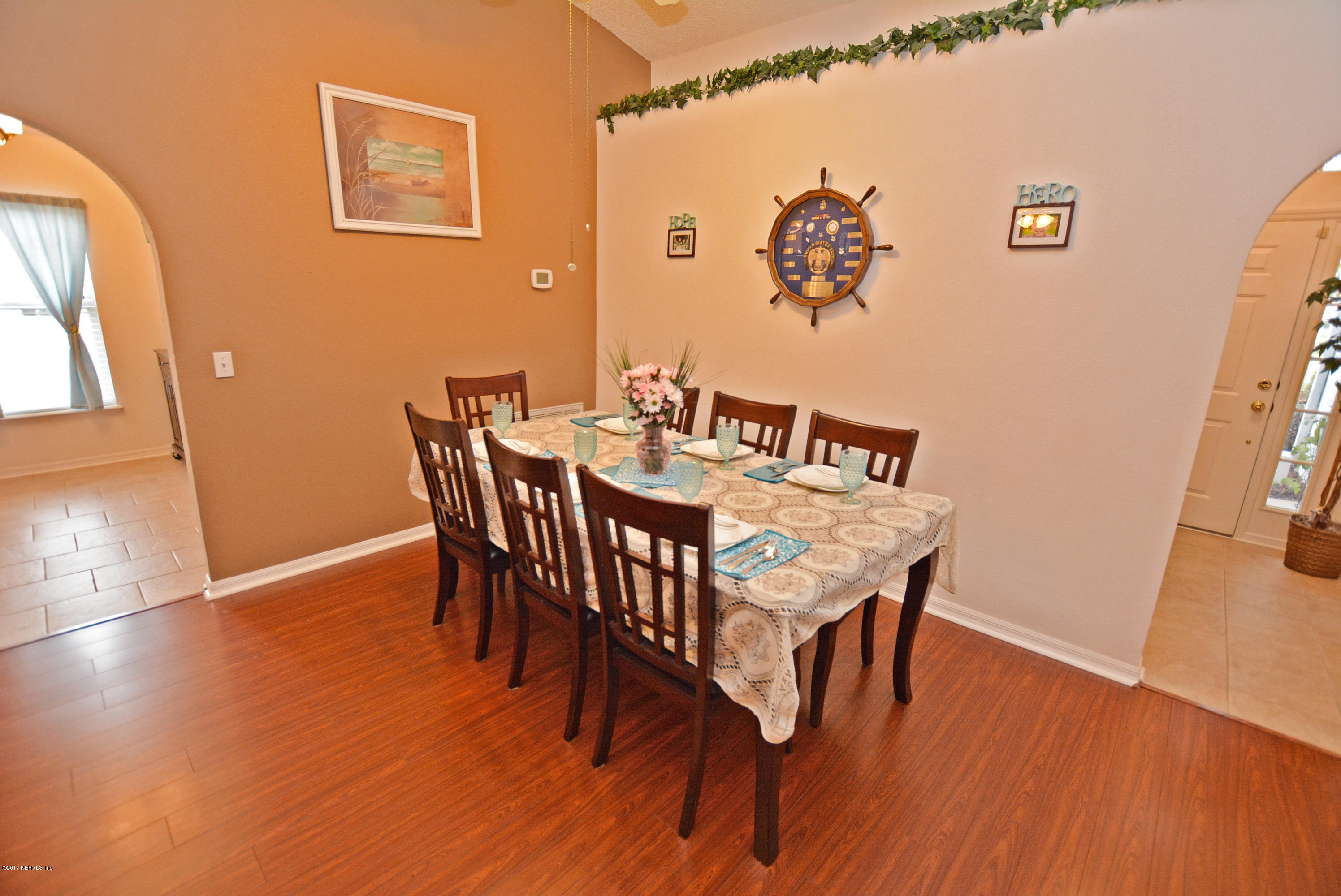7319 Gum Tree Road Jacksonville, FL 32244 - Photo 6 of 41 a view of a dining room with furniture and wooden floor