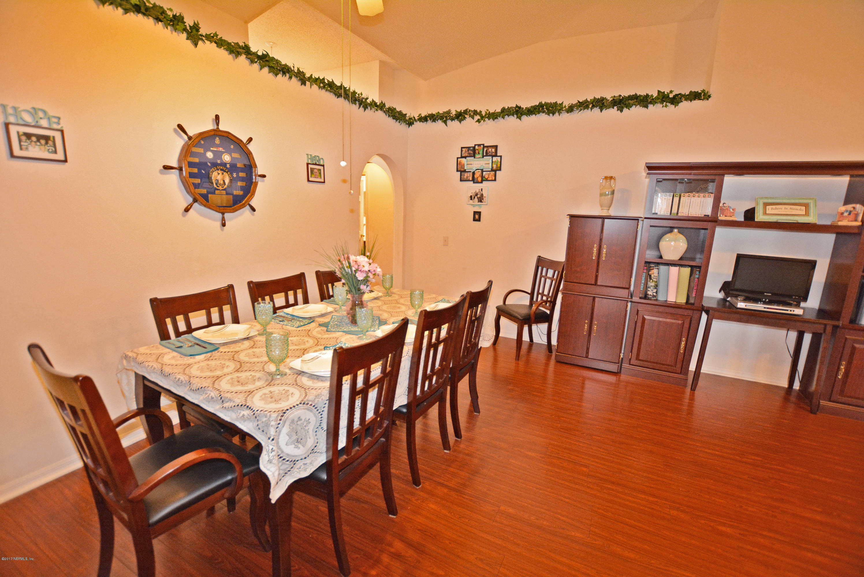 7319 Gum Tree Road Jacksonville, FL 32244 - Photo 7 of 41 a view of a dining room with furniture and wooden floor