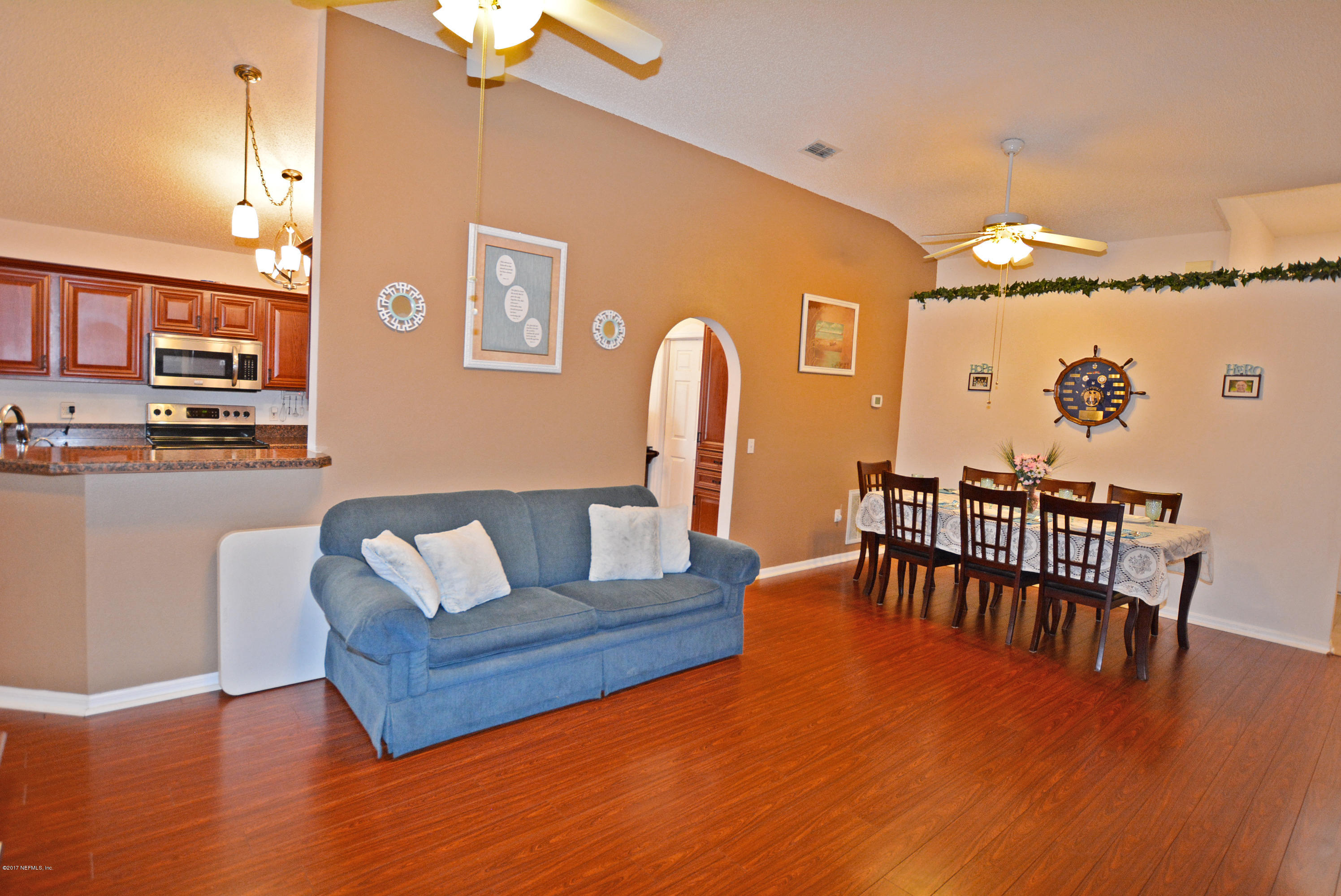 7319 Gum Tree Road Jacksonville, FL 32244 - Photo 9 of 41 a living room with furniture wooden floor and a dining table