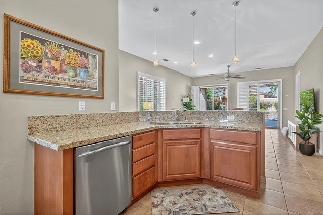 a kitchen with granite countertop lots of counter top space and potted plant