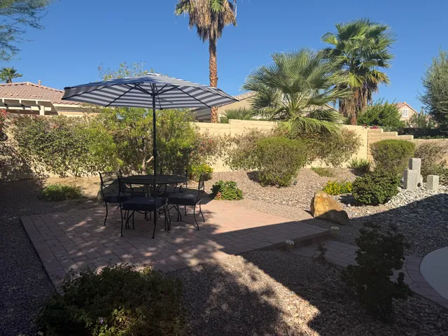 a view of a backyard with sitting area