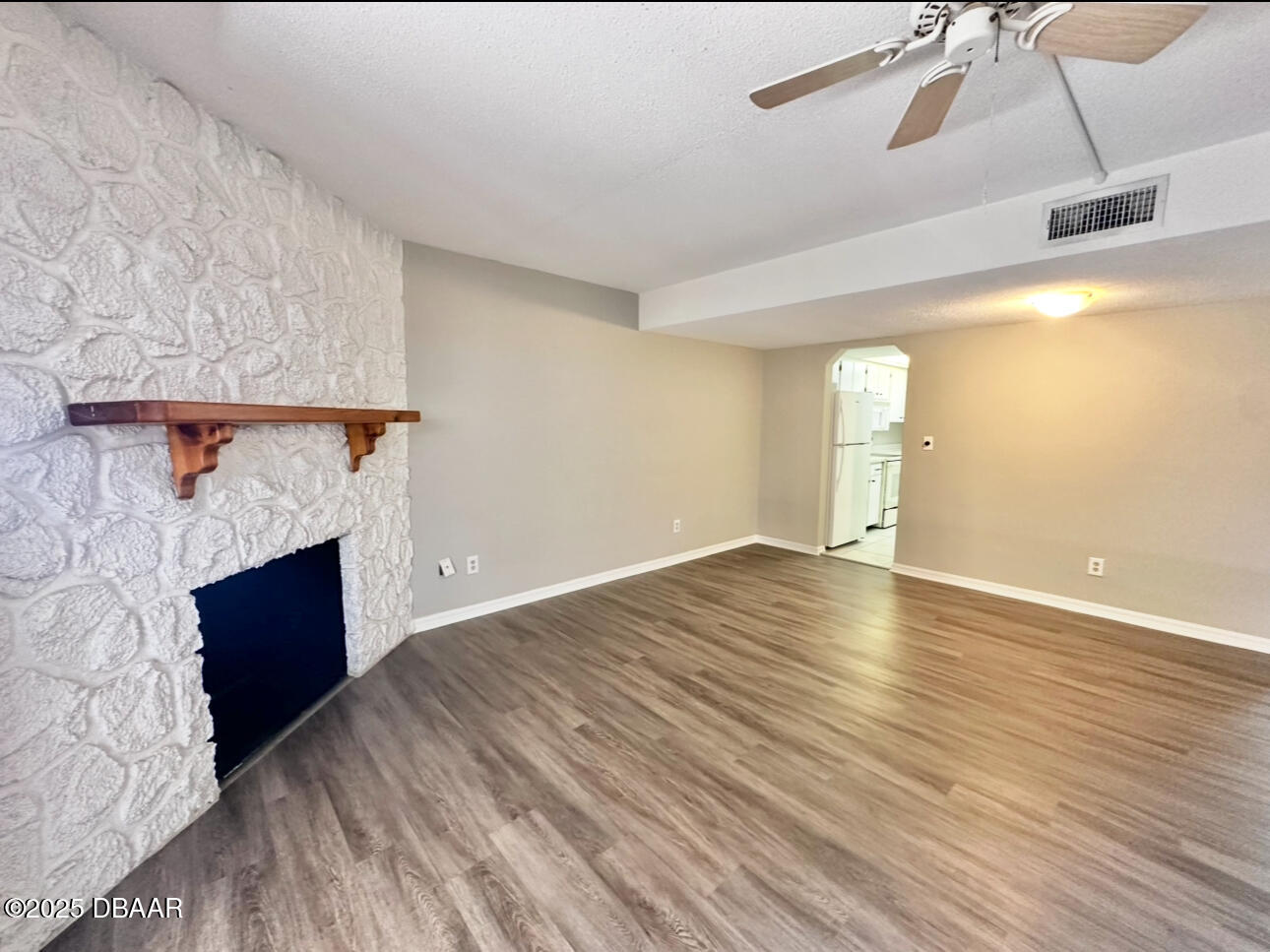 2250 South Palmetto Avenue, Unit J3 South Daytona, FL 32119 - Photo 4 of 20 a view of empty room with wooden floor and fireplace