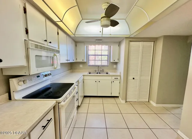 a kitchen with a stove a sink and a refrigerator
