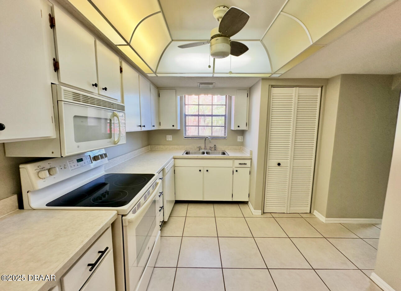 2250 South Palmetto Avenue, Unit J3 South Daytona, FL 32119 - Photo 5 of 20 a kitchen with a stove a sink and a refrigerator