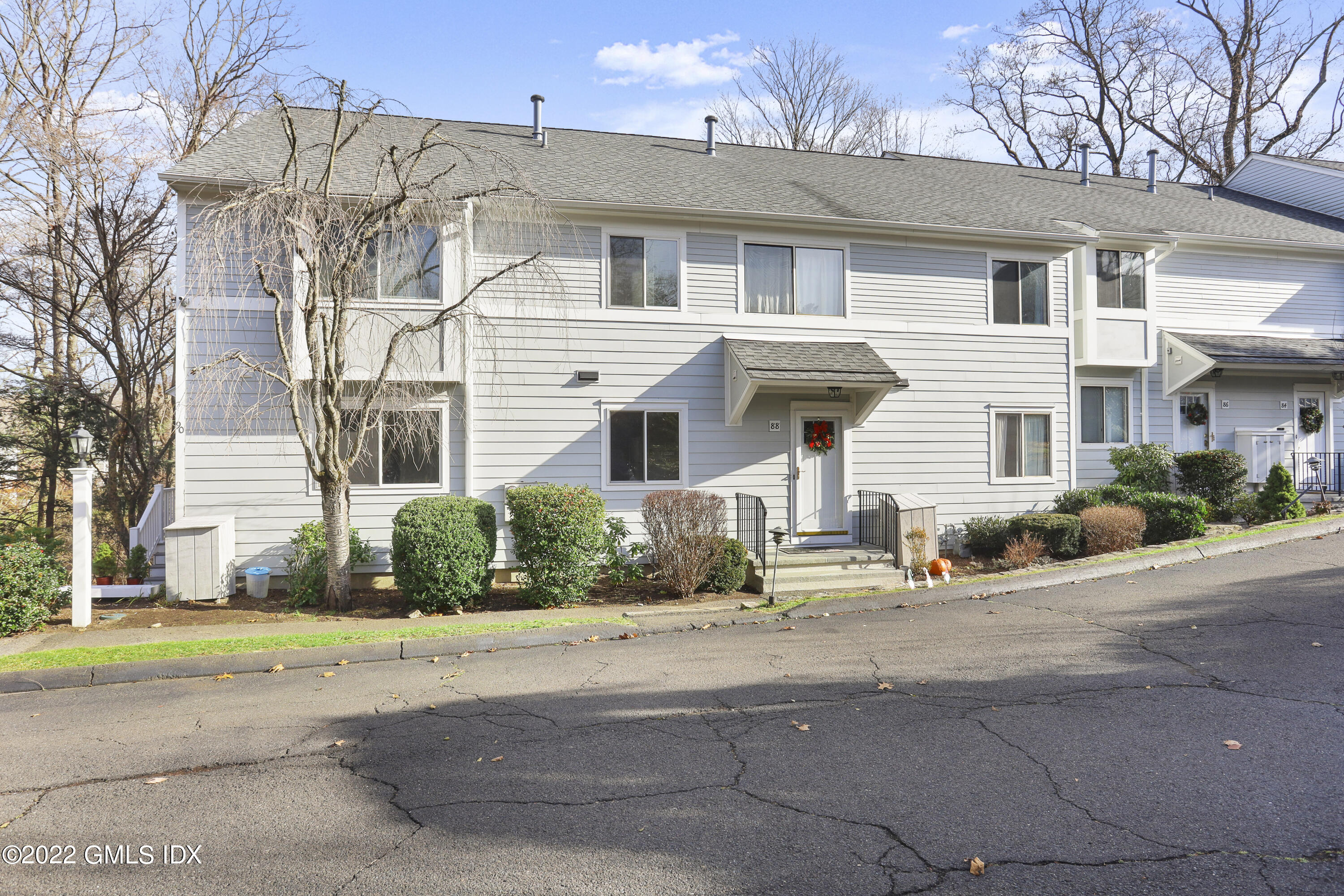 88 Silo Circle, Unit 88 Riverside, CT 06878 - Photo 3 of 20 front view of a house with a cars parked in front of it