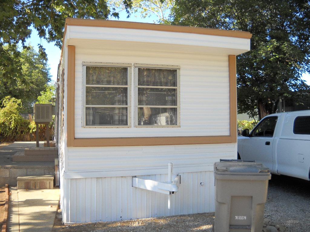 6870 Riverland Drive, Unit RIVERLAND Anderson, CA 96007 - Photo 1 of 8 a front view of a house with a garage