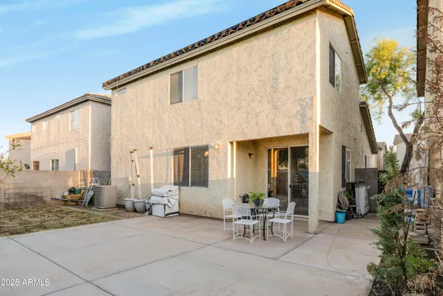 a backyard of a house with outdoor seating