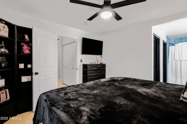 a bedroom with a bed and a flat screen tv