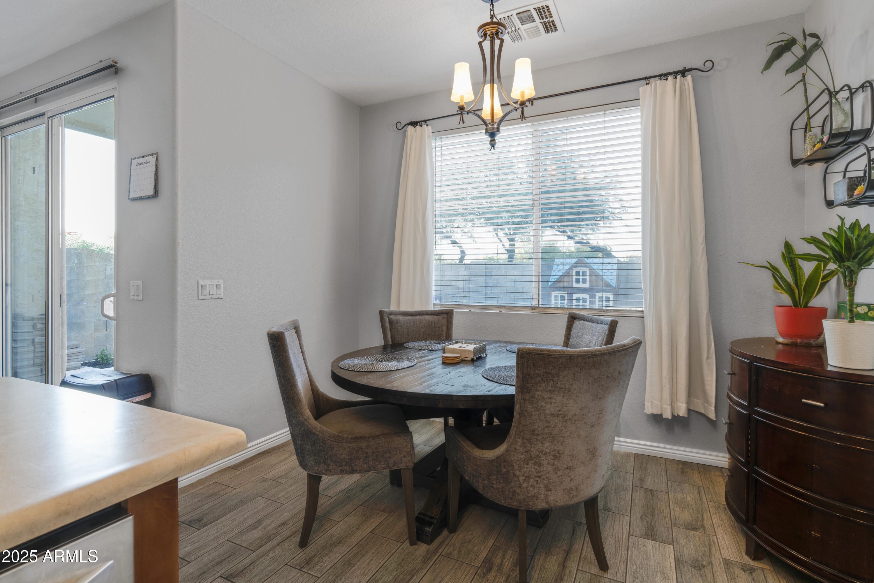 1512 East Chipman Road Phoenix, AZ 85040 - Photo 6 of 21 a view of a dining room with furniture and wooden floor