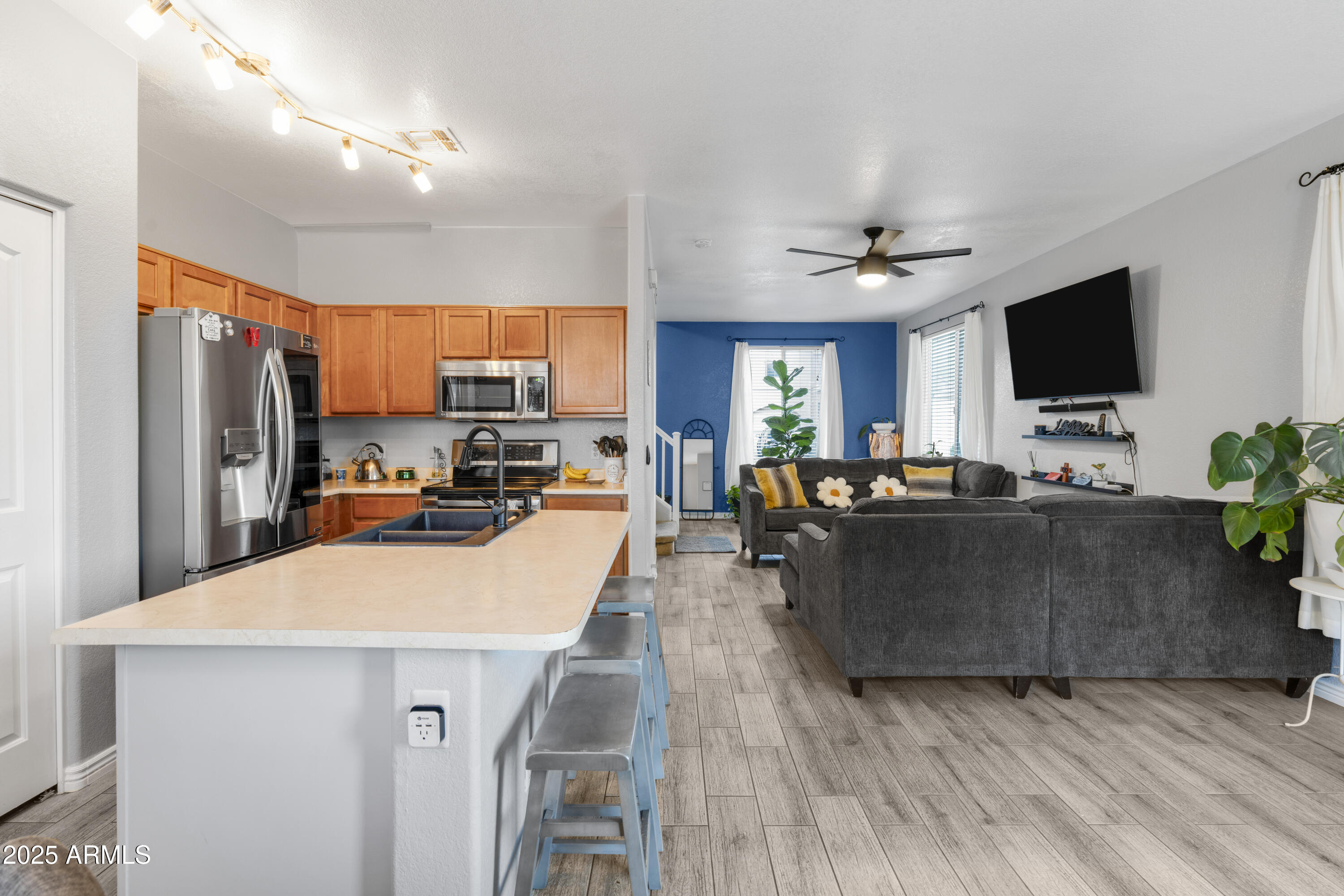 1512 East Chipman Road Phoenix, AZ 85040 - Photo 7 of 21 a living room with furniture a flat screen tv and kitchen view
