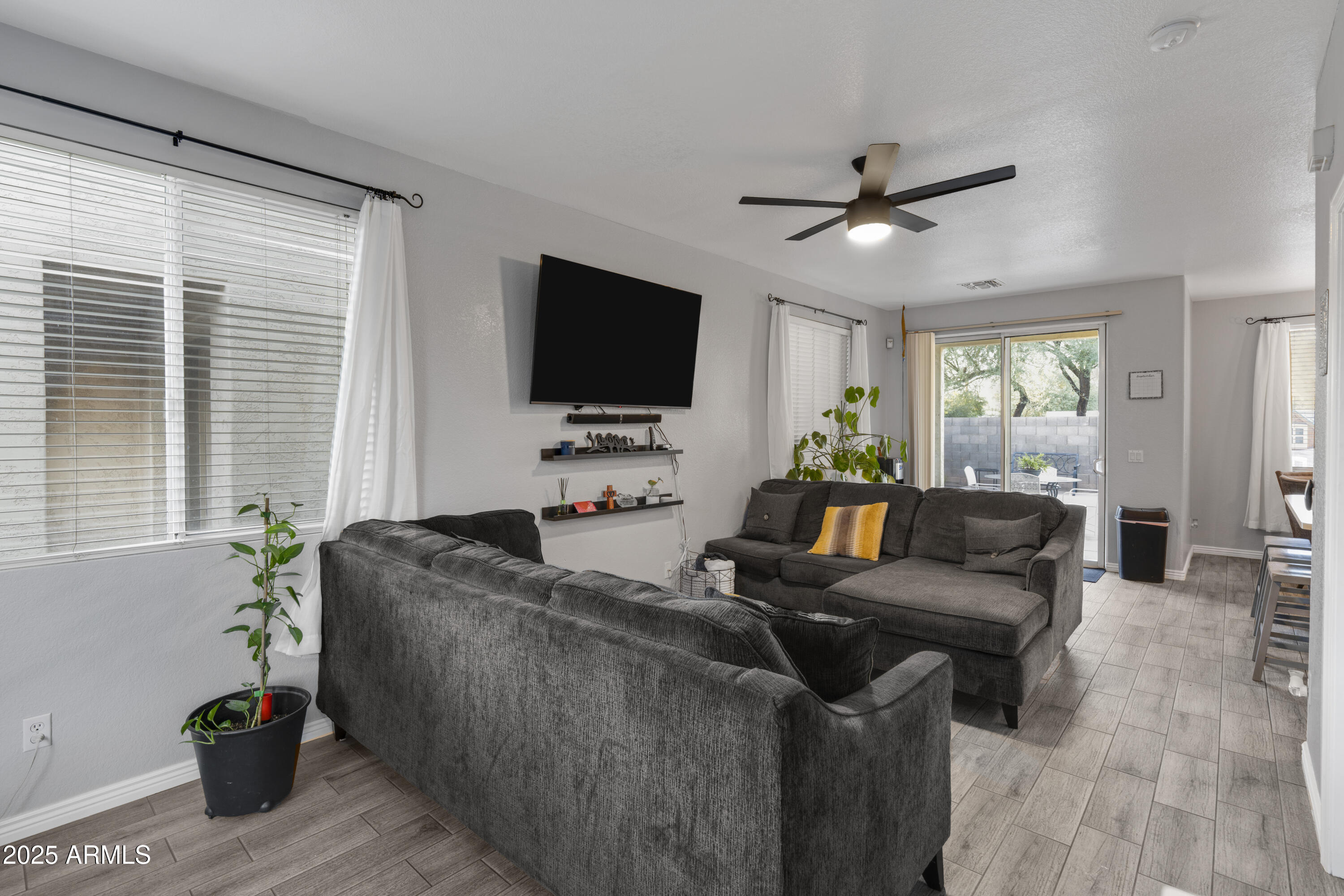 1512 East Chipman Road Phoenix, AZ 85040 - Photo 8 of 21 a living room with furniture and a flat screen tv