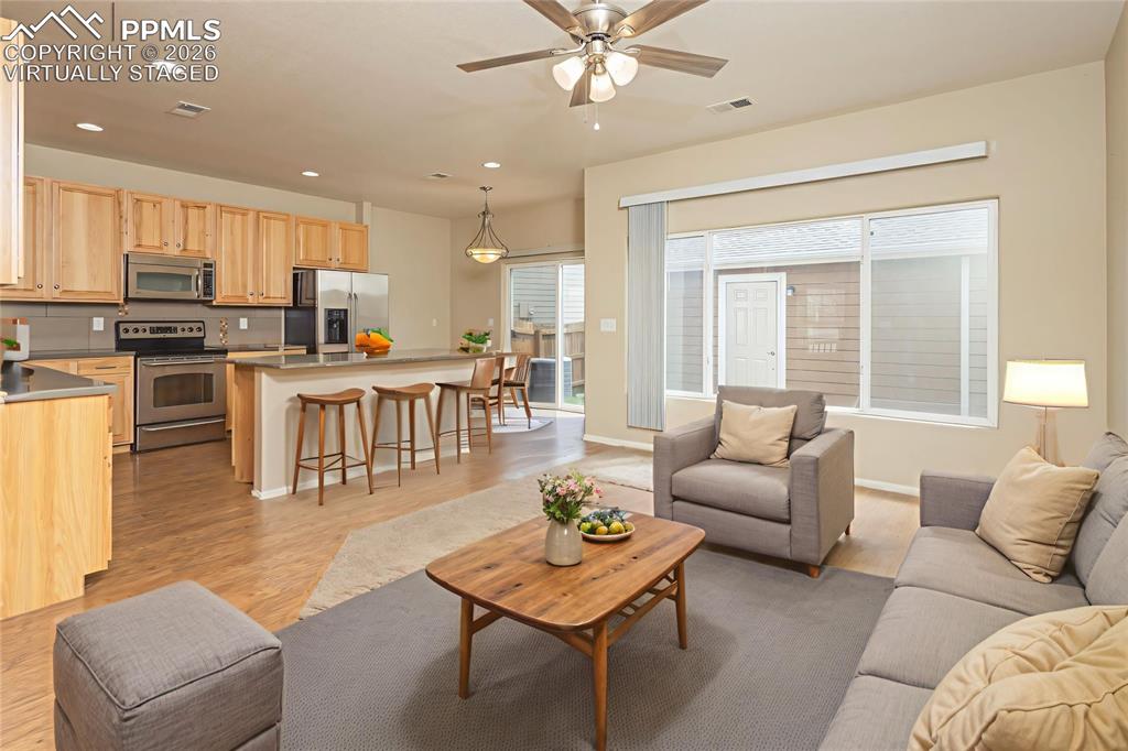 4815 Harrier Ridge Drive Colorado Springs, CO 80916 - Photo 8 of 33 Living area featuring a ceiling fan, recessed lighting, and light wood finished floors Virtually Staged