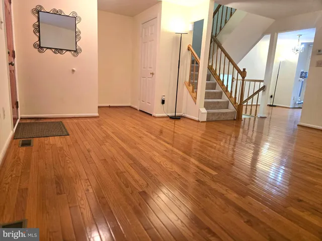 a view of an entryway with wooden floor