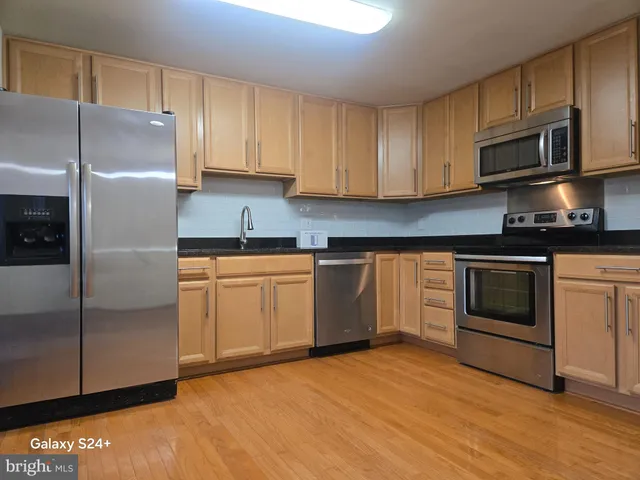 a kitchen with a sink stove and refrigerator