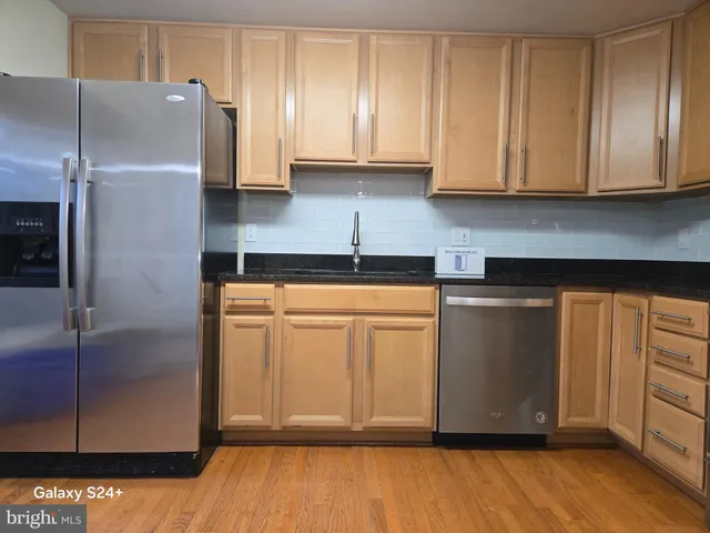 a kitchen with cabinets and stainless steel appliances