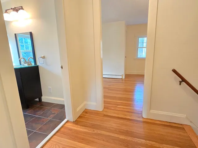 a view of a hallway with wooden floor and glass door