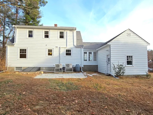 a view of a house with backyard and sitting area