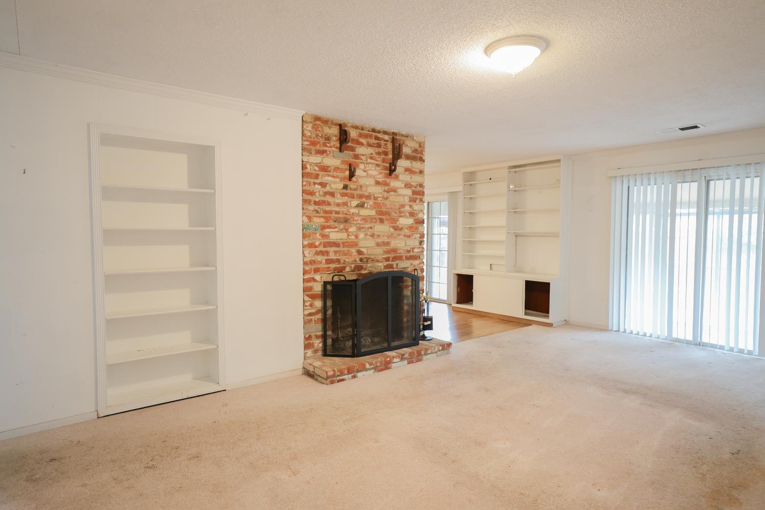 805 B Street Davis, CA 95616 - Photo 3 of 17 an empty room with fireplace and windows
