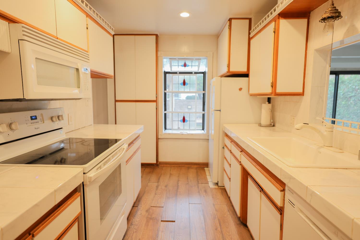 805 B Street Davis, CA 95616 - Photo 7 of 17 a kitchen with a refrigerator a sink and wooden cabinets