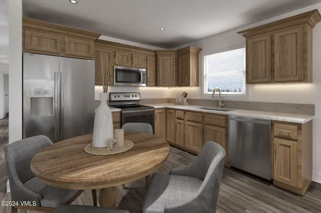 a kitchen with stainless steel appliances granite countertop a sink window and refrigerator