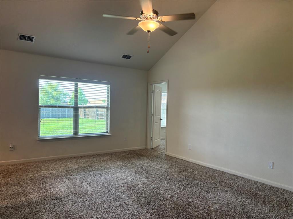 3095 Barzona Road Forney, TX 75126 - Photo 6 of 23 an empty room with a window and a fan