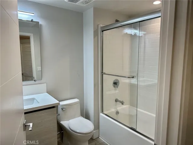 a bathroom with a shower a toilet and a bathtub