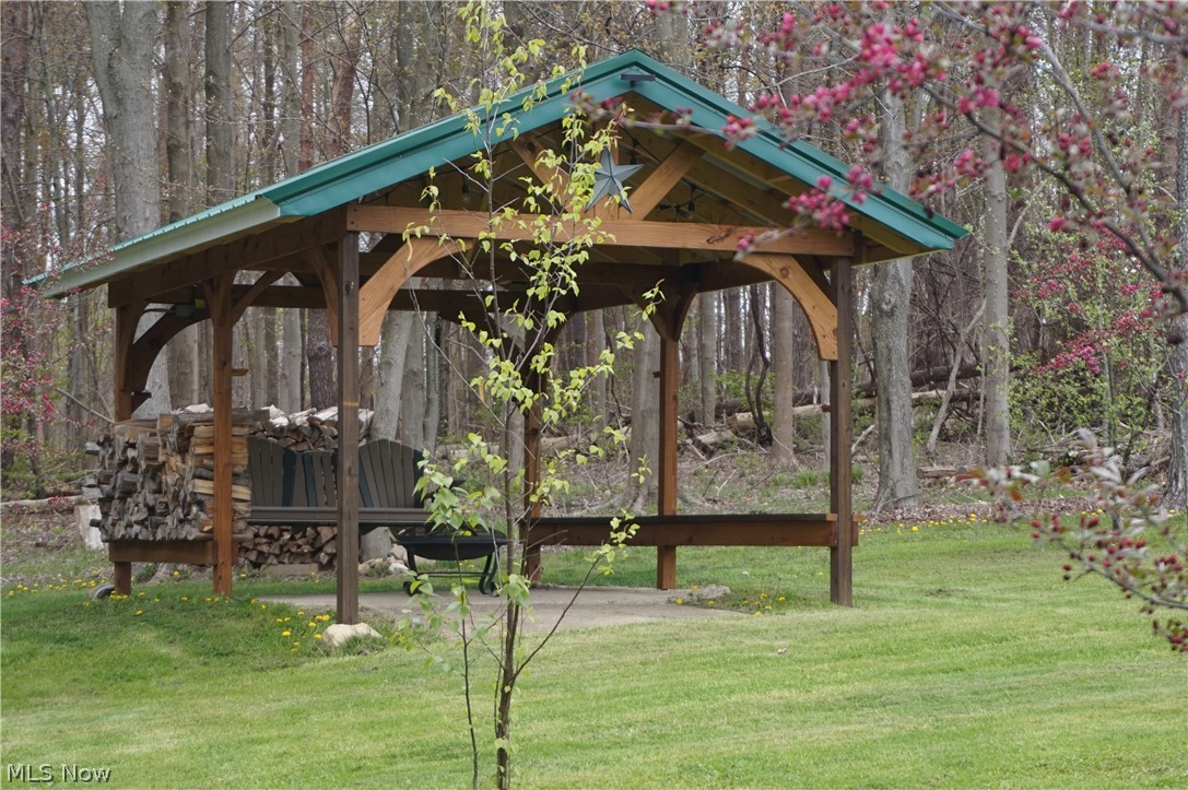 2605 Plymouth Ridge Road Ashtabula, OH 44004 - Photo 41 of 50 Pavillion with metal roof, custom arches, bench seat on both sides, fire pit.