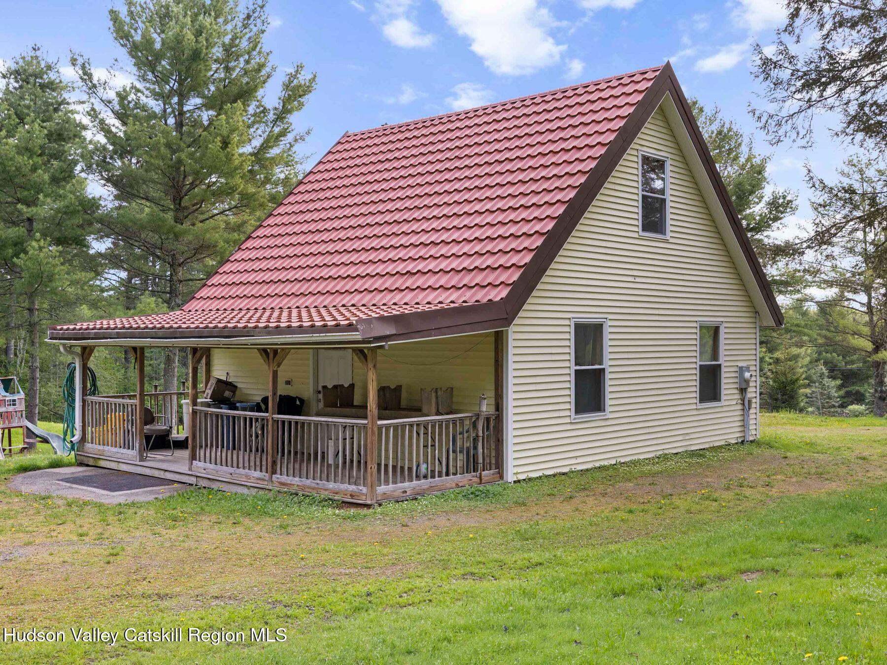 137 Mountain Pond View Road Gilboa, NY 12076 - Photo 9 of 38 a backyard of a house with yard table and chairs