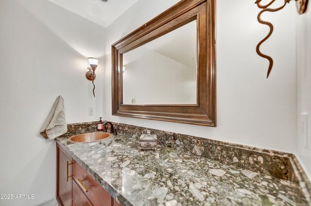 a spacious bedroom with a bed a dresser and a flat screen tv