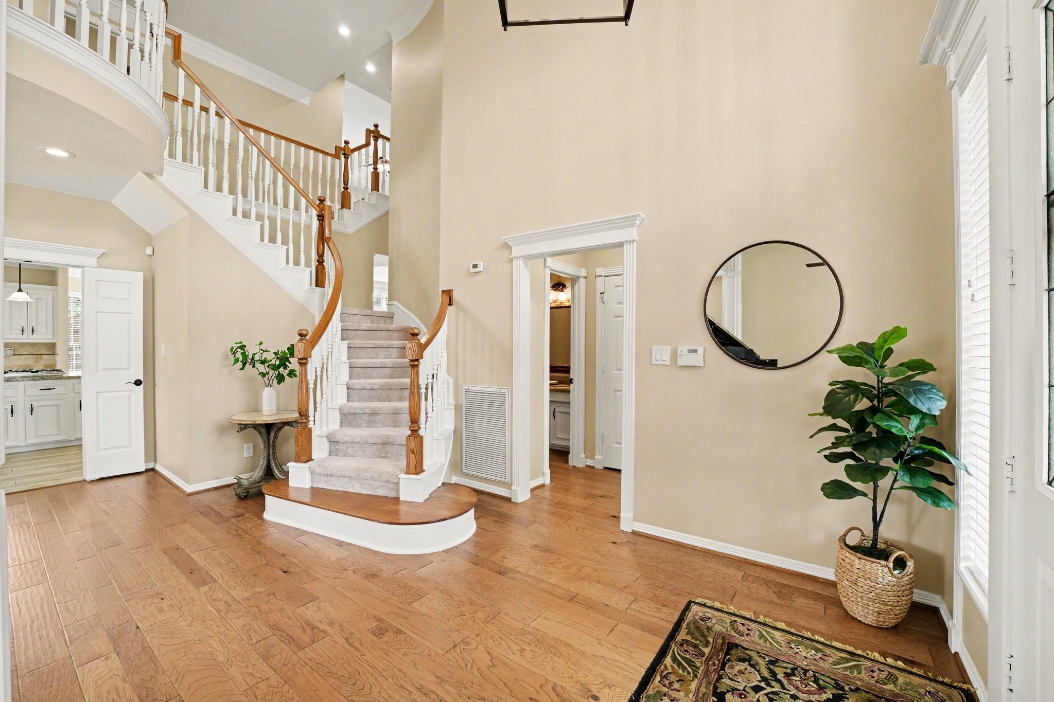 3411 Fir Forest Drive Spring, TX 77388 - Photo 5 of 39 Another view of the grand staircase and the hallway that connects to the half bathroom on the left and the primary bedroom on the right.