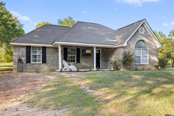 a front view of a house with a garden and porch